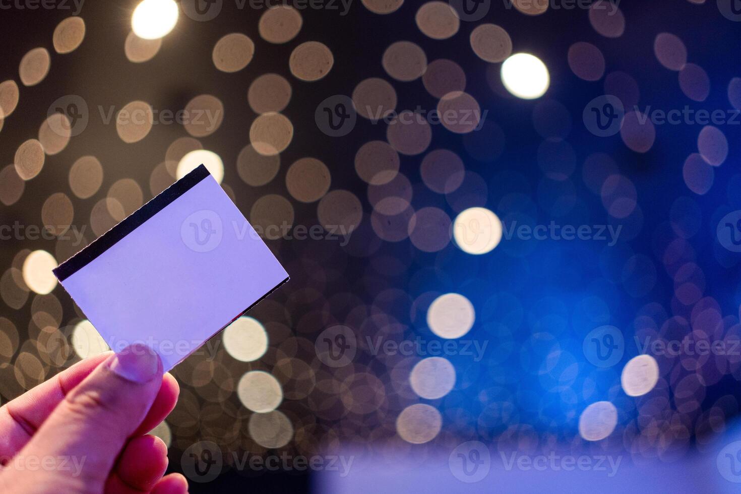 Blank movie paper ticket for mockup design in hand. photo