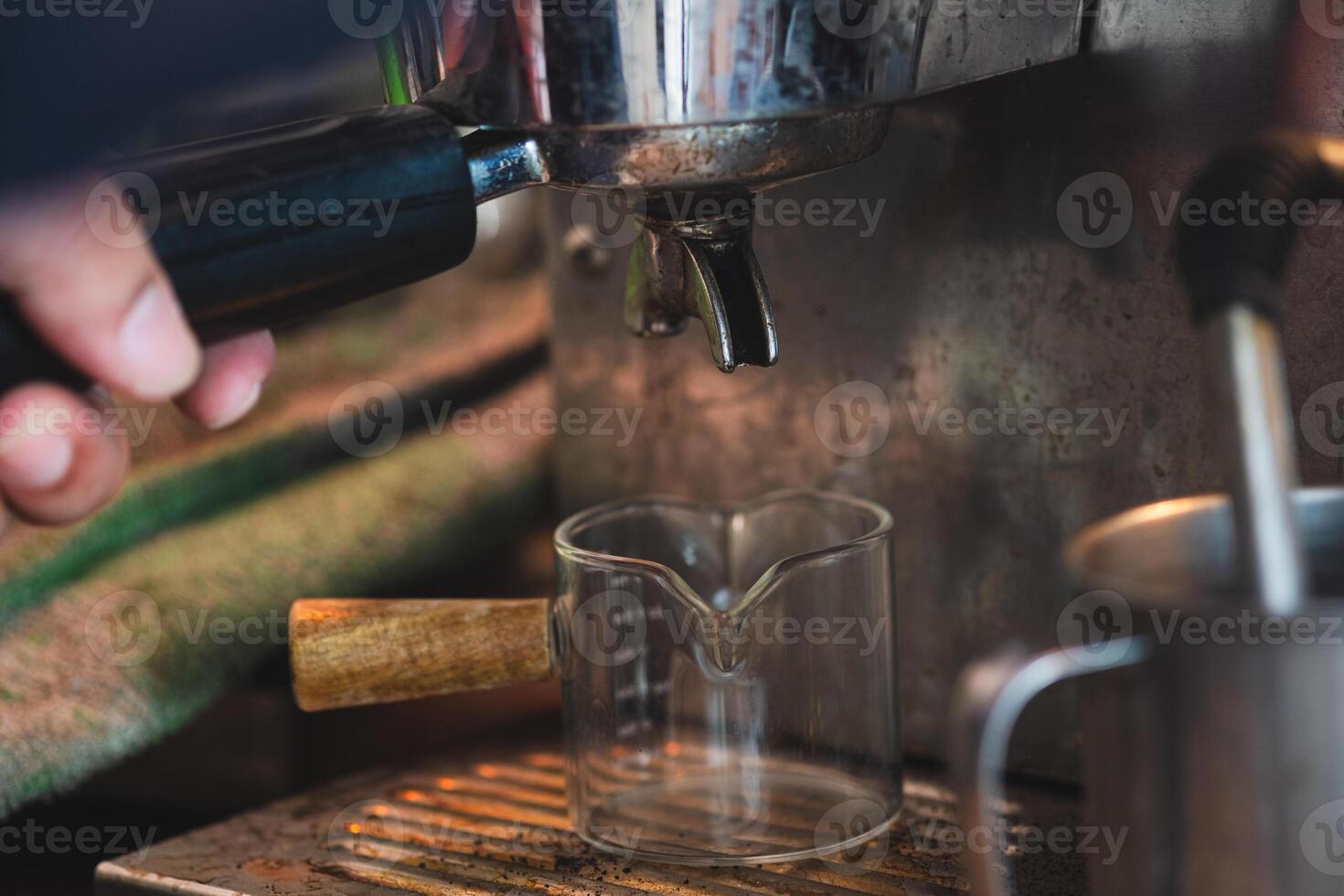 A hand make a coffee from coffee machine making a coffee photo