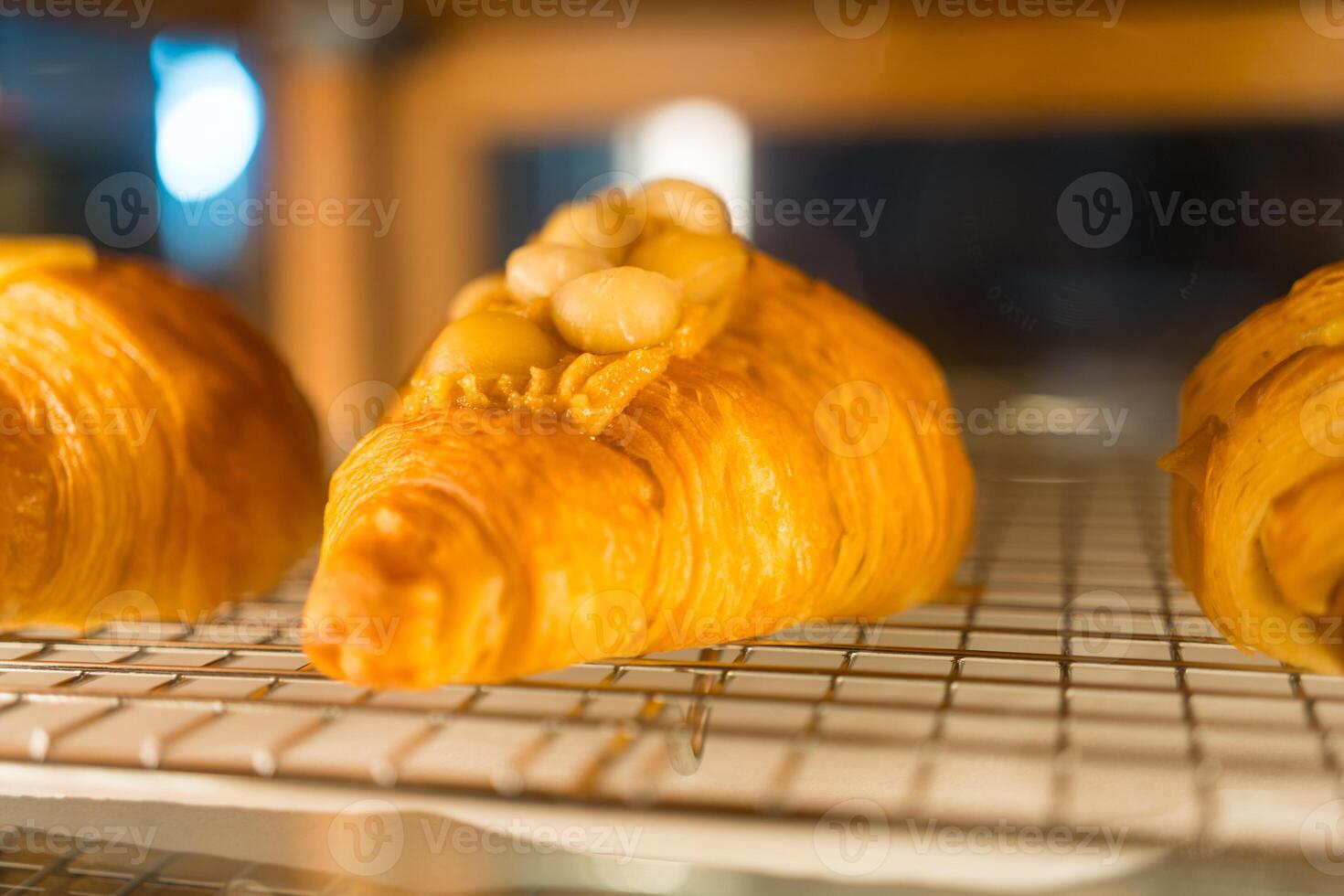 Fresh tasty croissants in showcase at coffee shop photo