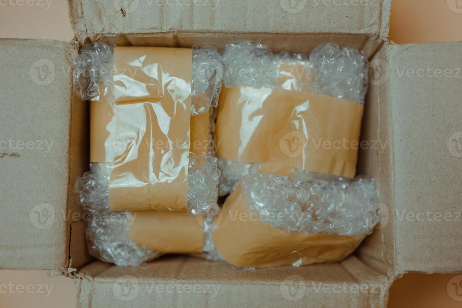 Package wrapped in white bubble wrap and brown adhesive tape. photo