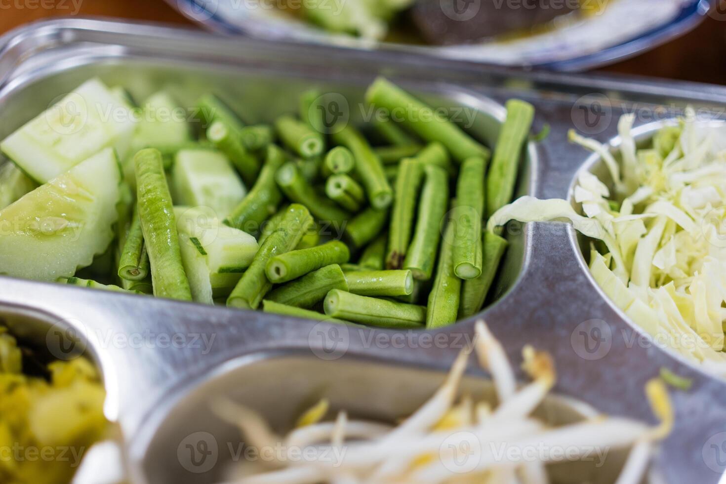 Buffet line in silver with green long bean slice photo
