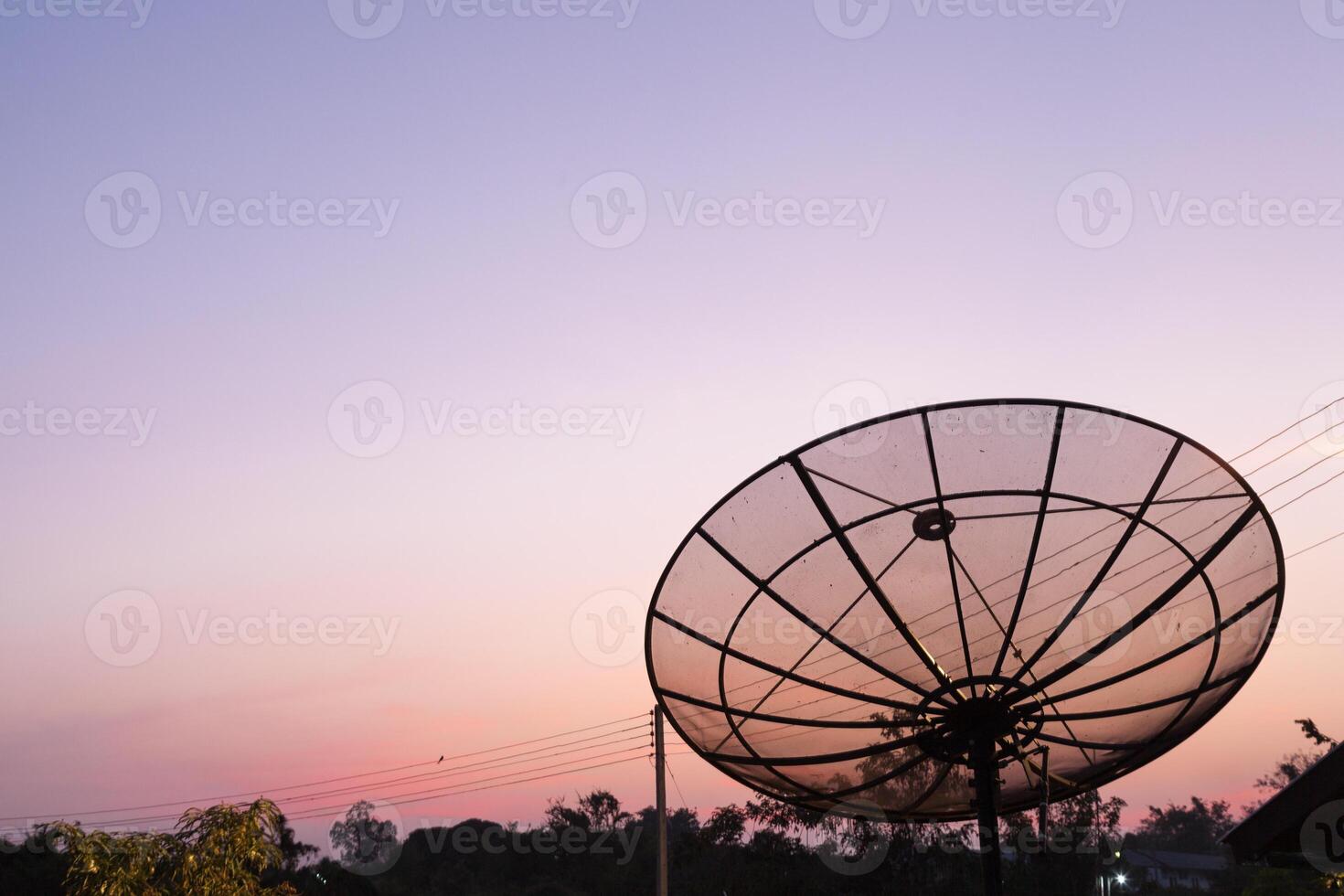 A satellite dish on a pole photo