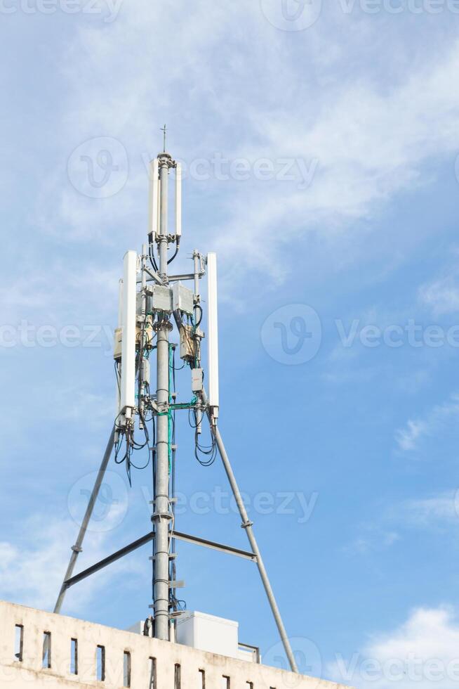 A tower with a cell phone tower on top photo
