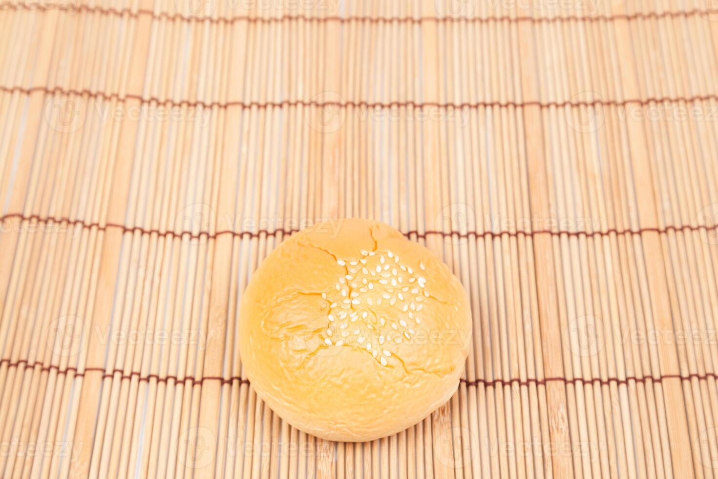 A small yellow cake on a bamboo mat photo