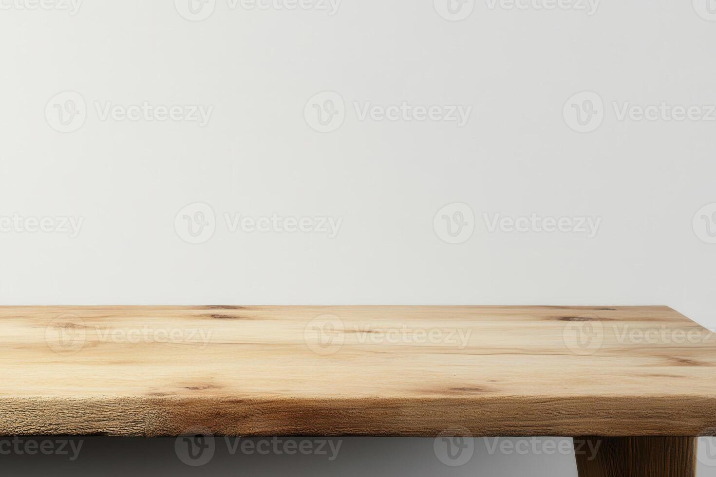 A wooden table against a plain wall background. photo