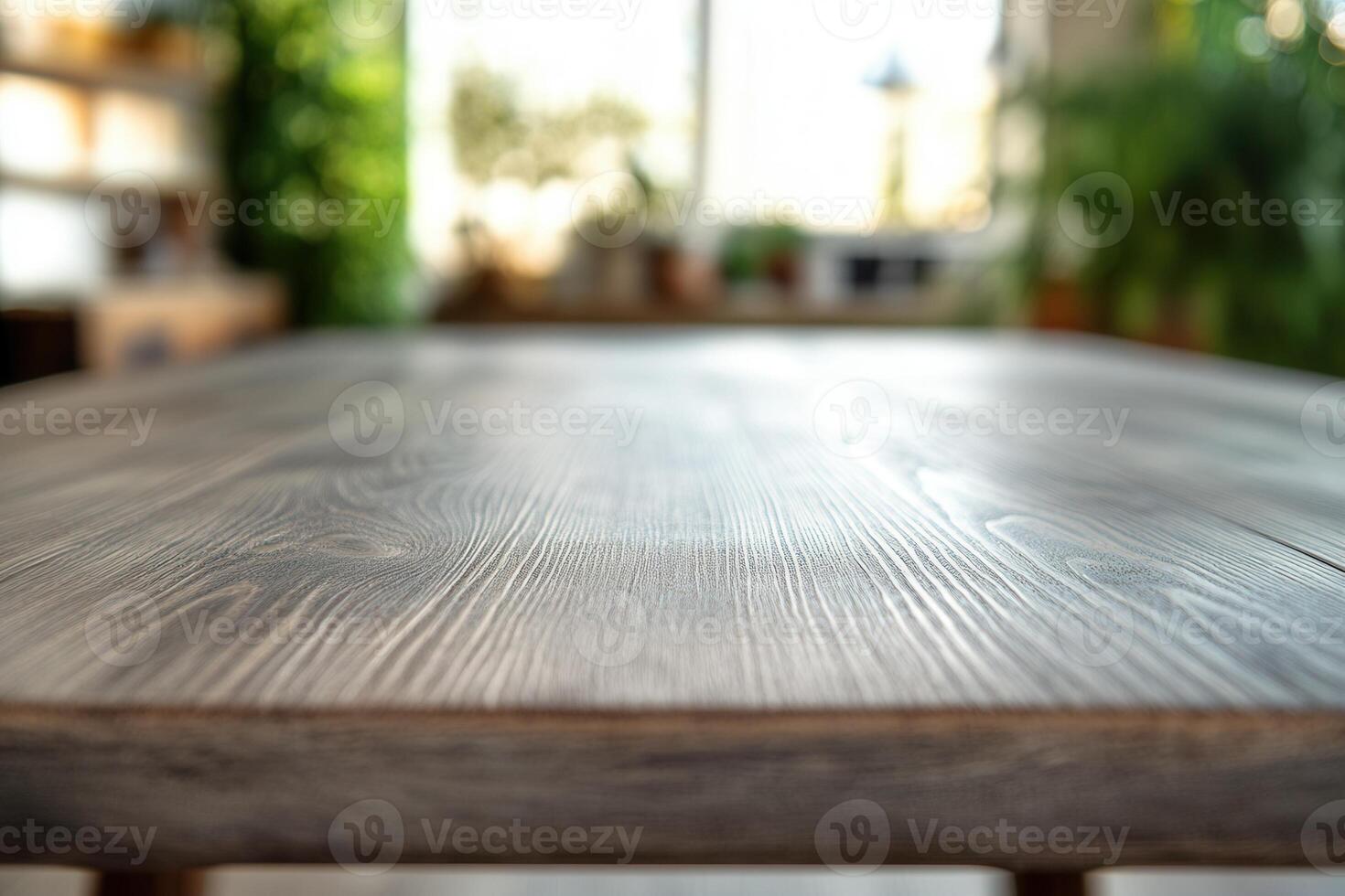 Close-up of a wooden table in a bright, green space. photo