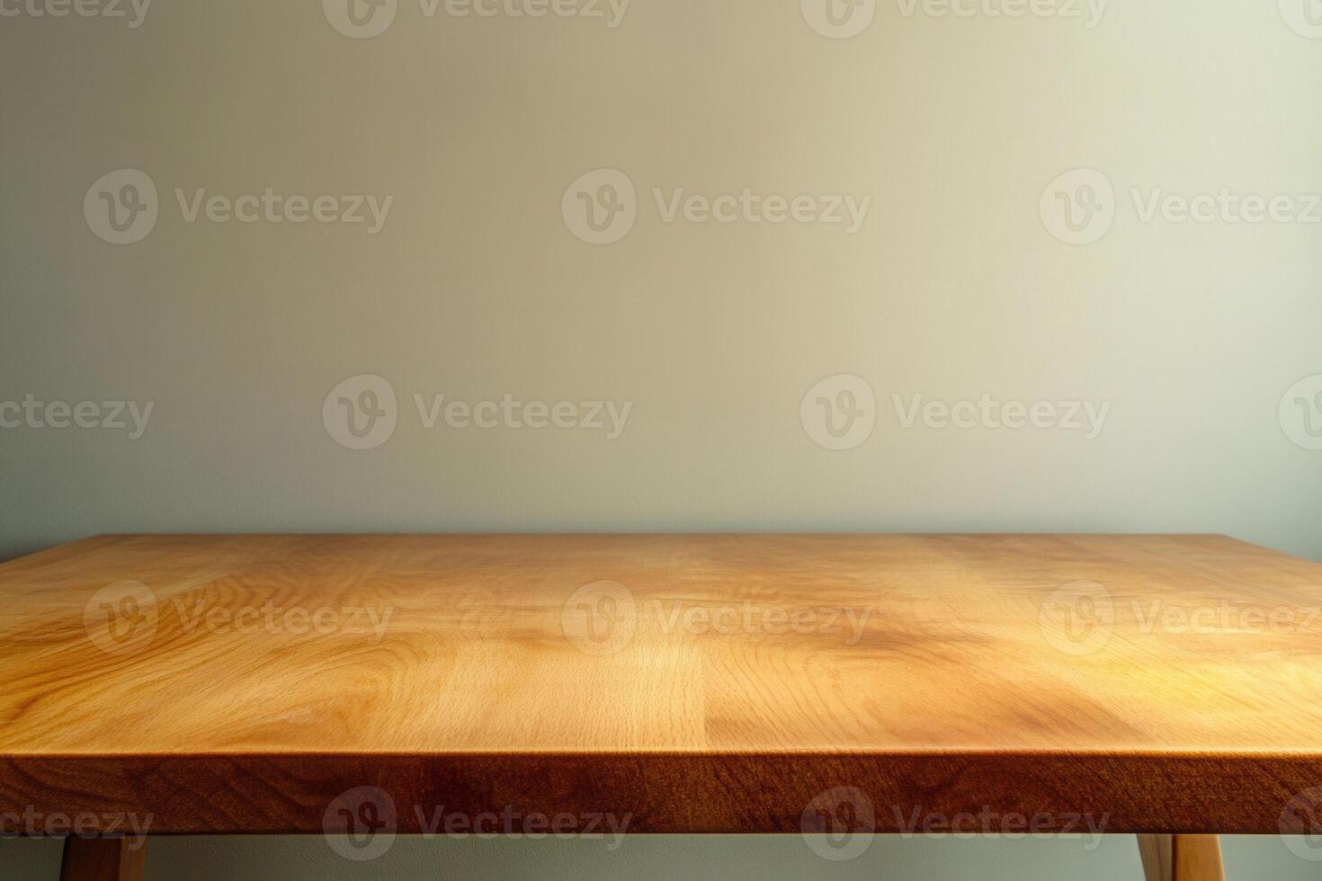 A simple wooden table against a plain wall. photo