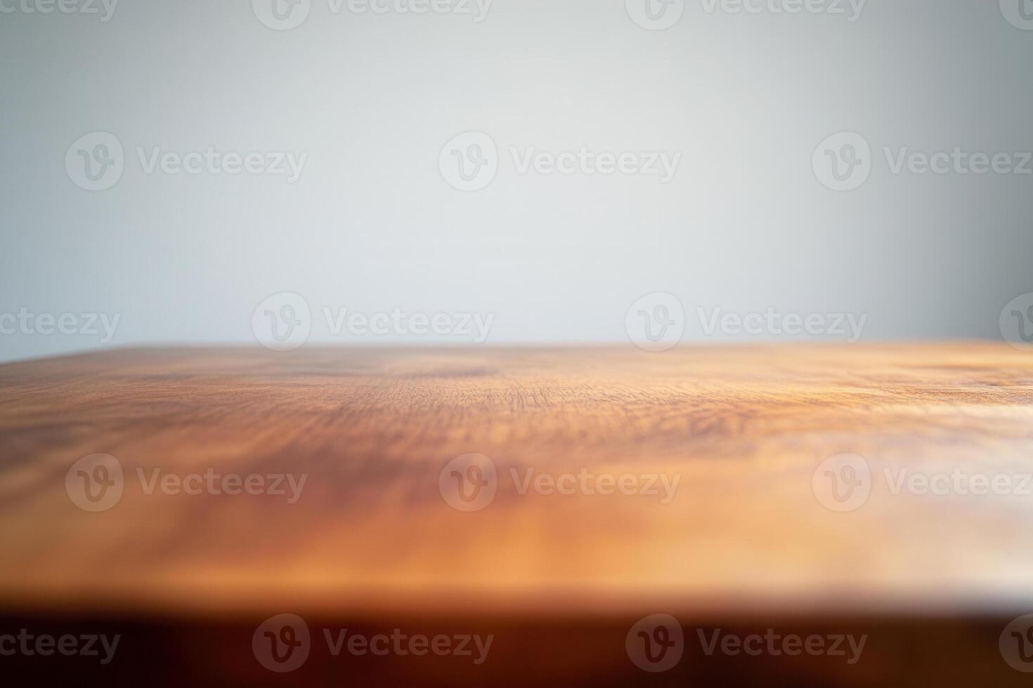 Close-up of a wooden table surface with a plain background. photo
