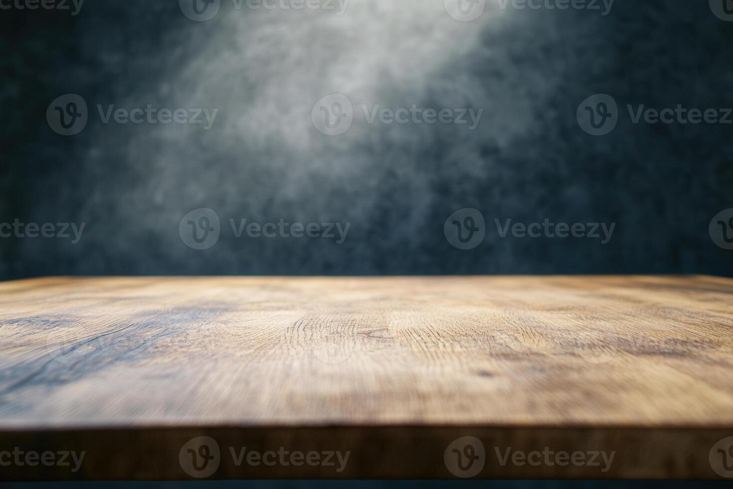 Wooden table with a spotlight effect on a dark background. photo