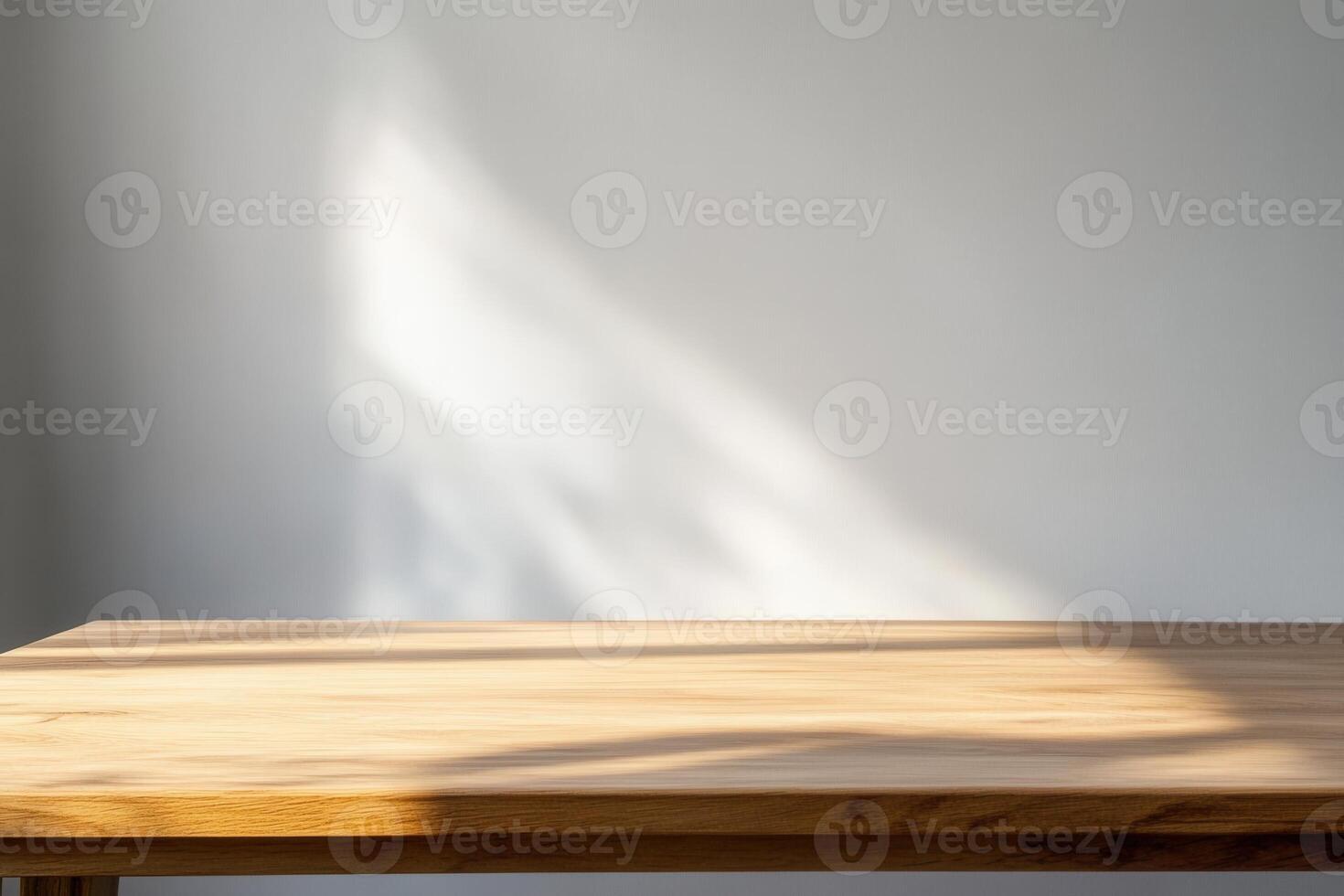 Simple wooden table with soft shadows on a wall. photo