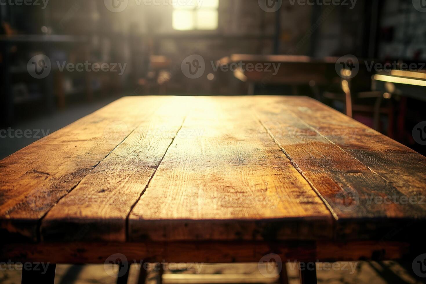Rustic wooden table in a sunlit workshop setting. photo