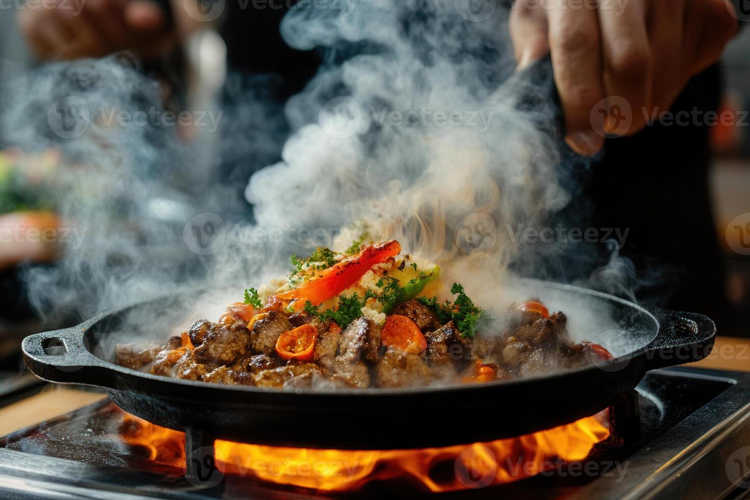 Sizzling dish being prepared with smoke and vibrant ingredients. photo