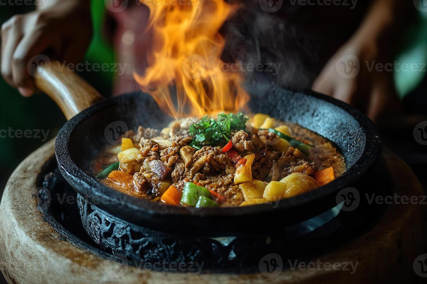 Flaming beef stir-fry in a sizzling hot pan. photo