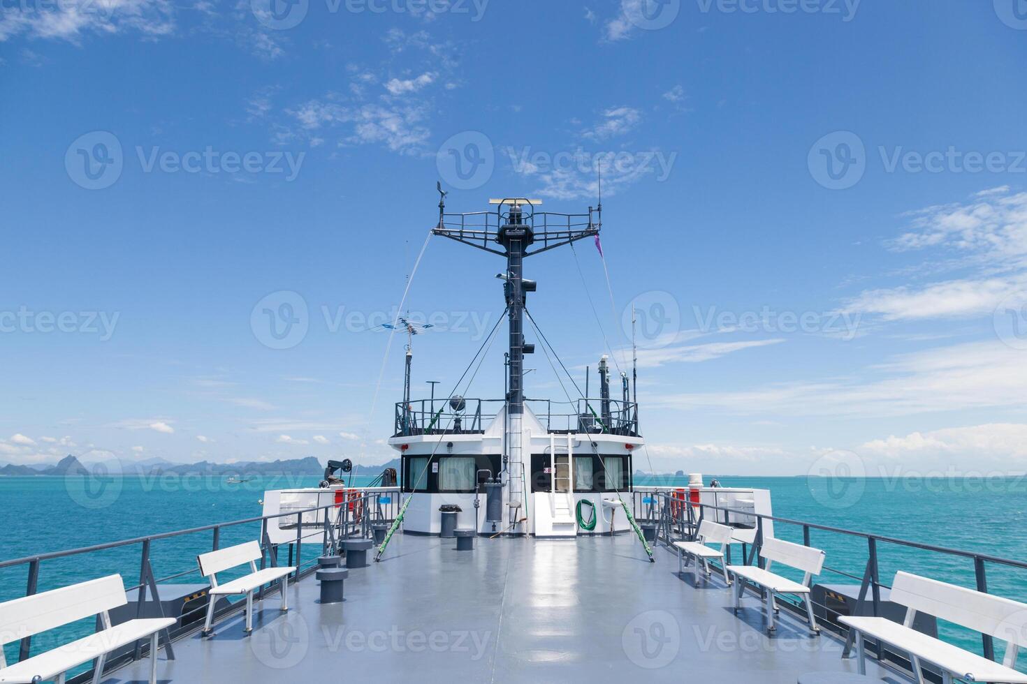 A boat with a white deck and a blue sky photo