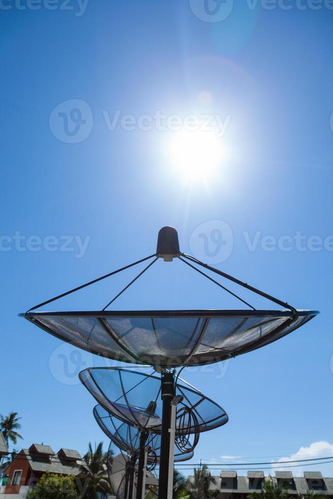 A large metal dish with a sun shining on it photo
