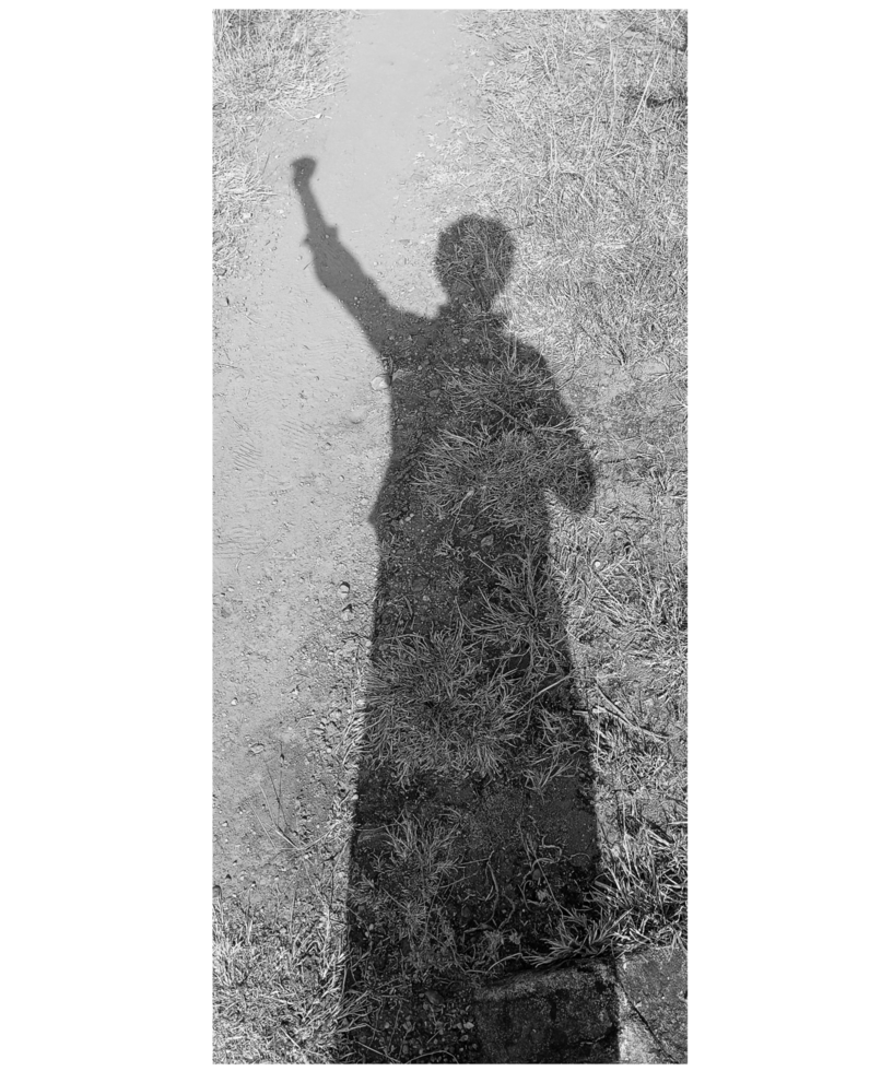 Black and white silhouette of a man raising his voice against injustices. png