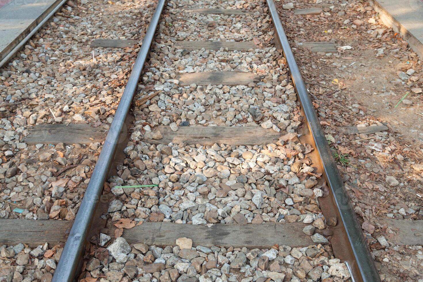 A train track with gravel and rocks on it photo