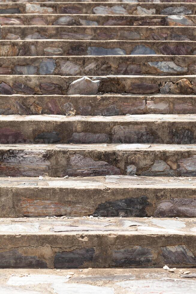 A man on a skateboard riding down a set of stairs photo