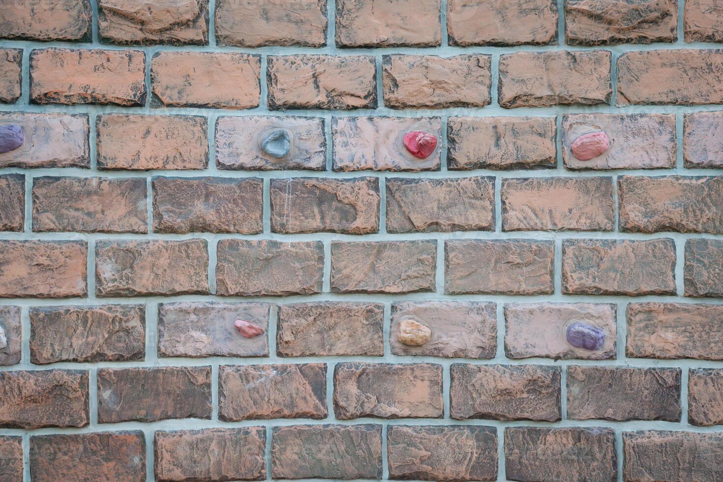 A brick wall with many different colored buttons photo