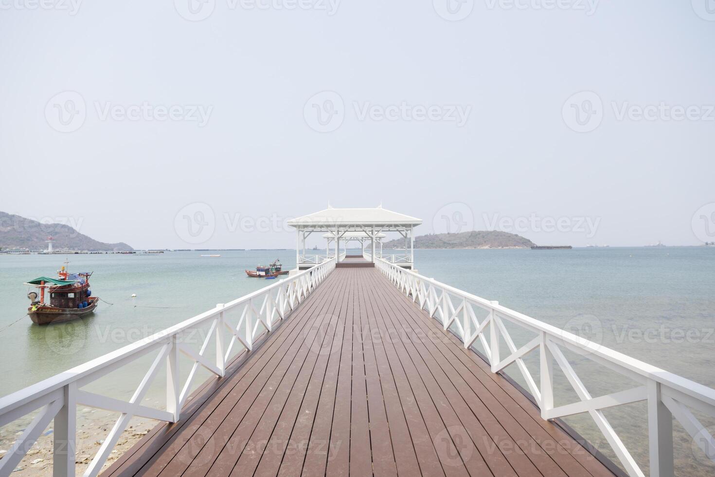 A wooden pier with boats on it photo