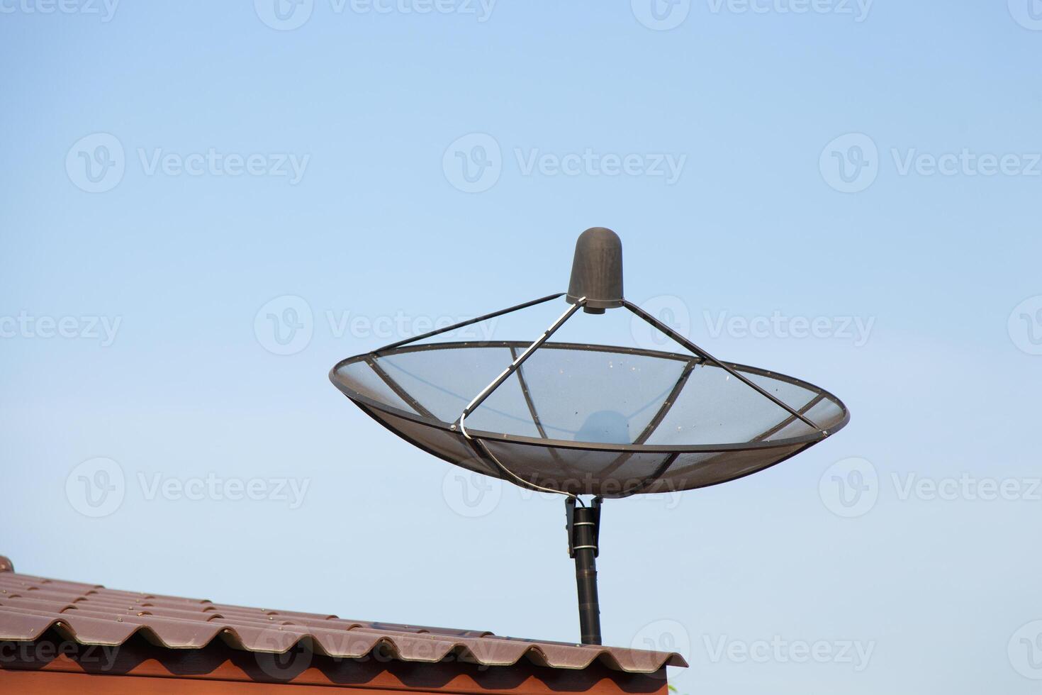 A satellite dish on top of a roof photo