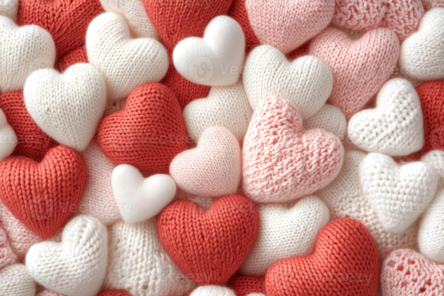 Red and white knitted heart shaped decorations photo