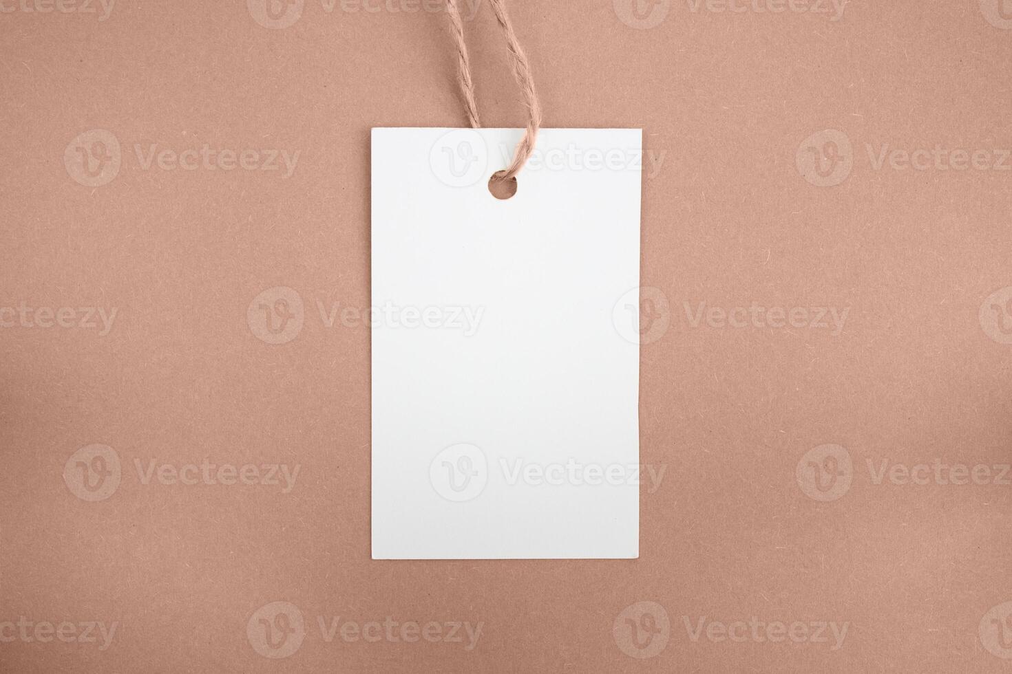 White price tag on a brown background. Mockup. Place for text. photo