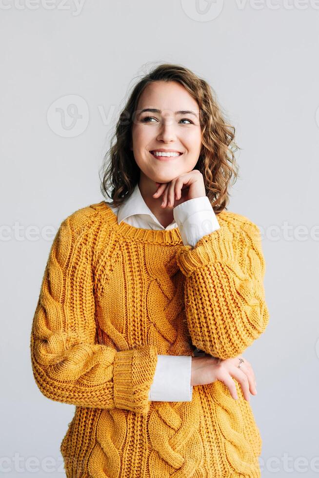 Young Woman Dreaming of Future Success - Smiling, Happy Student Contemplates Opportunities - Holding Chin, Reflecting on Ideas - Isolated on White Background - Conceptual Image of Hope and Aspiration. photo