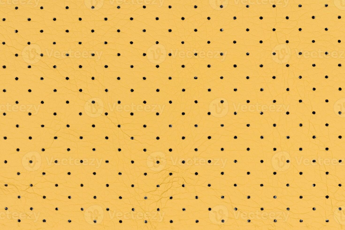 Yellow color abstract artificial leather with small dots and holes pattern for background photo