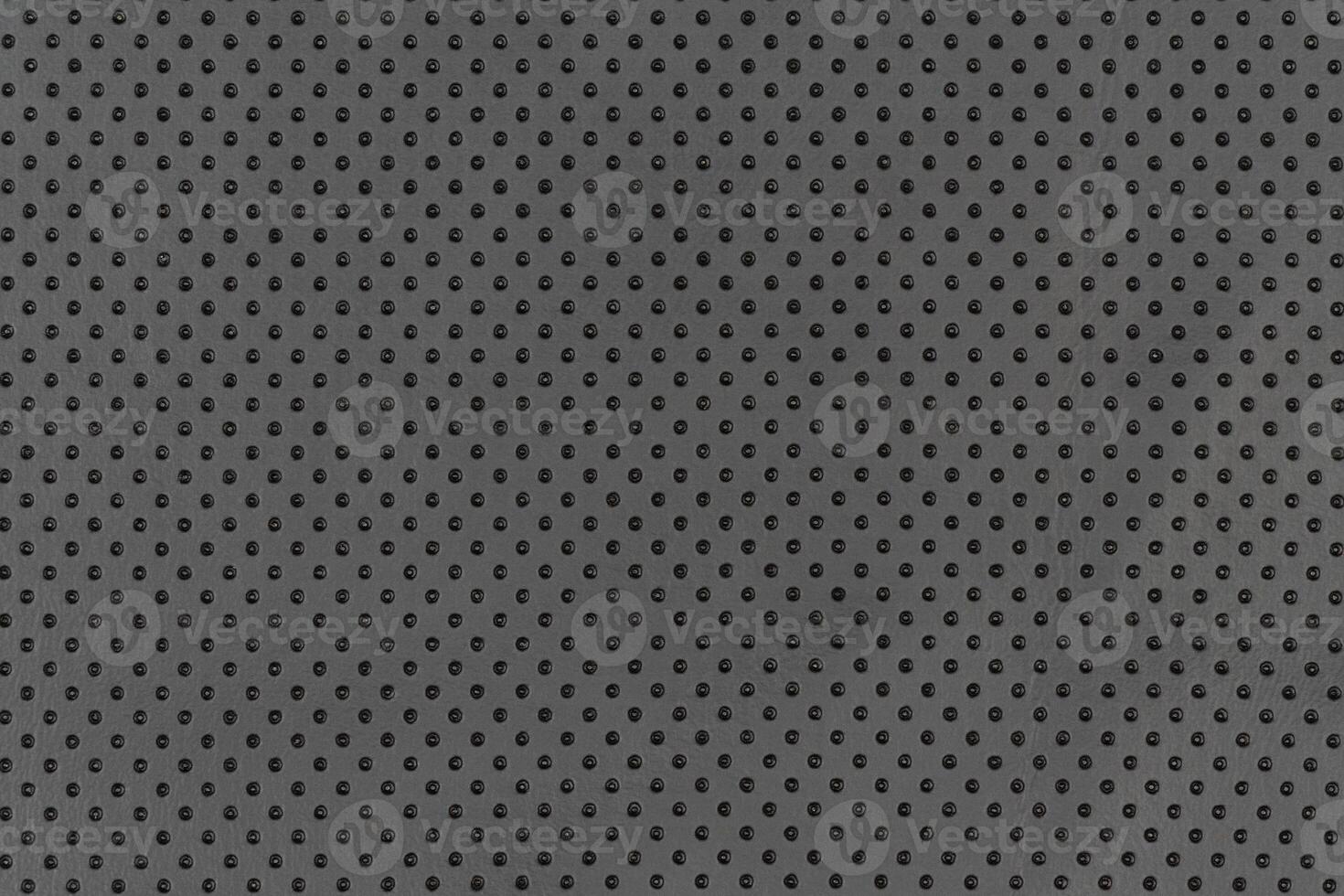 Black color abstract matte material fabric smooth surface with small dots holes pattern background photo
