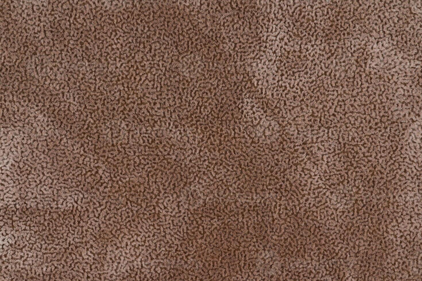Brown color fabric material with short pile fluffy and soft texture background. Image of tawny cloth photo