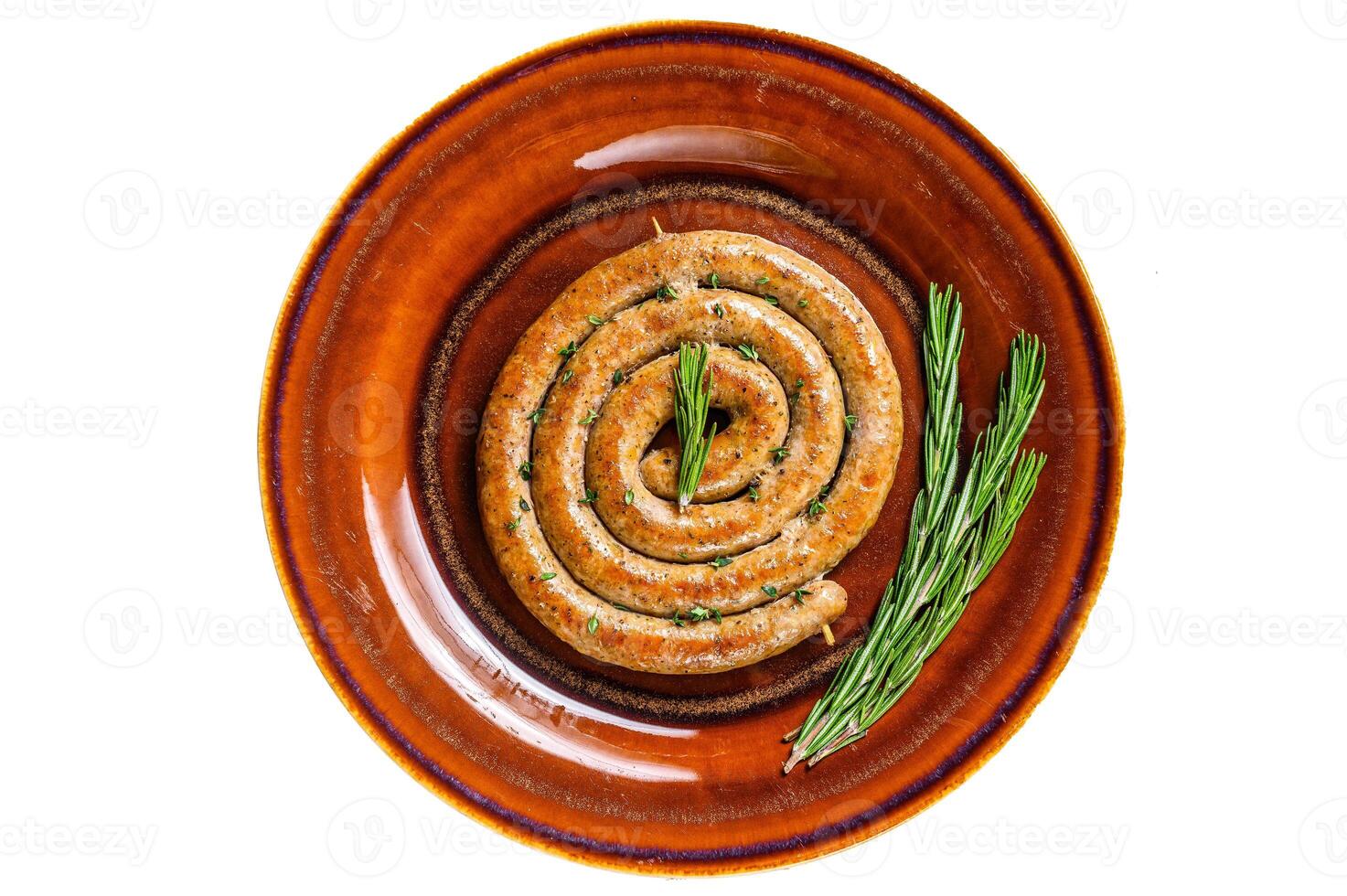Grilled spiral sausage from pork and beef meat on a rustic plate. Isolated on white background. photo