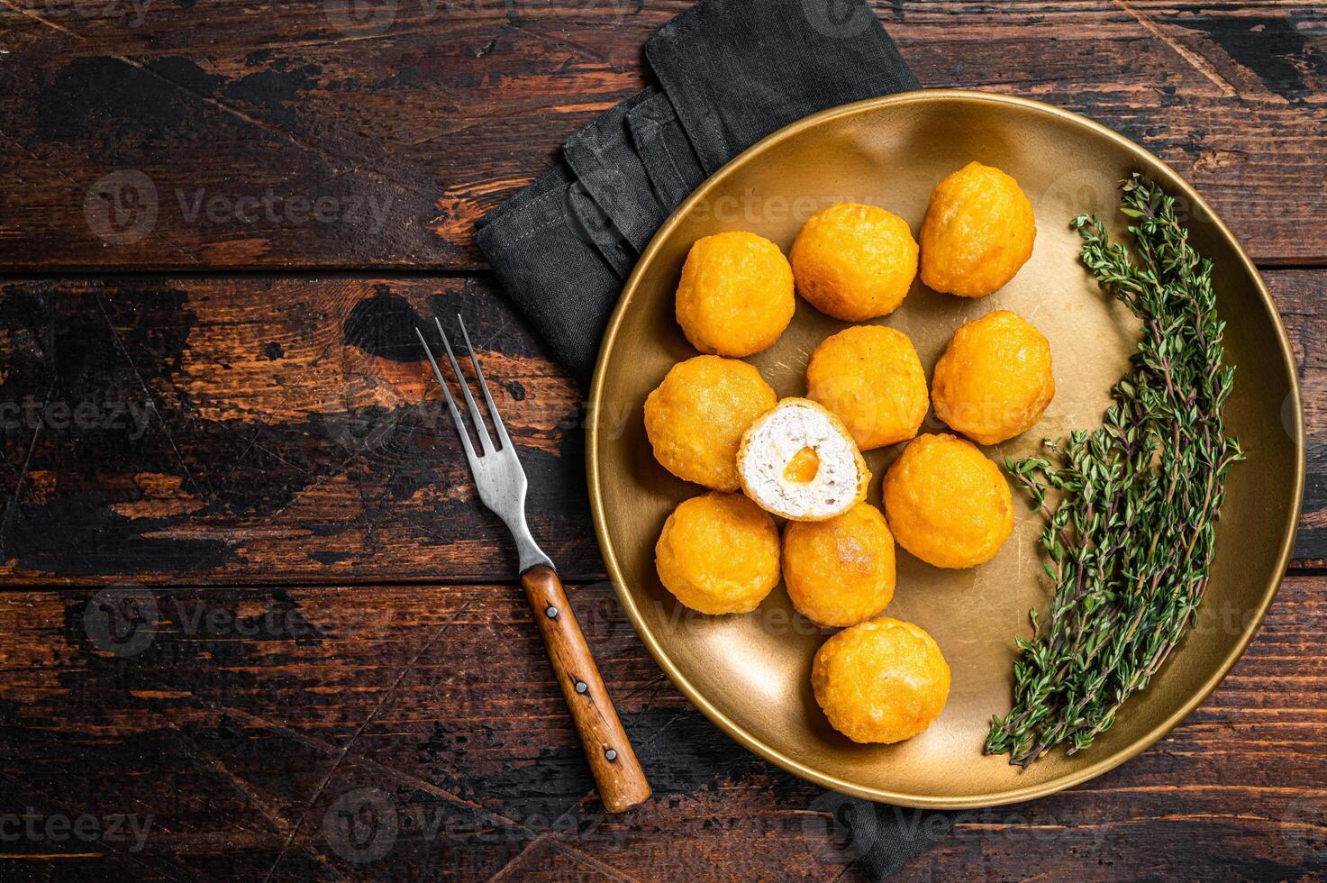 Fried crispy round chicken nuggets with Cheese. Wooden background. Top view. Copy space photo