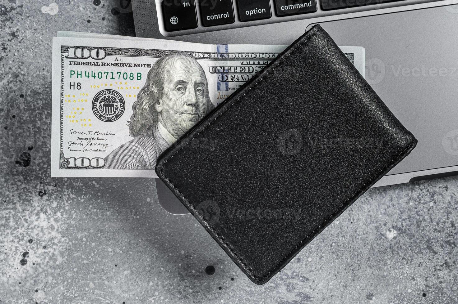 Workplace with stylish leather wallet with money, Laptop. Gray background. Top view. Copy space photo