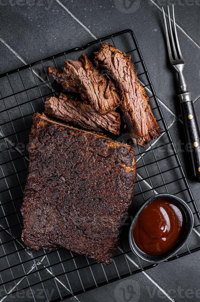 Chopped Beef Brisket barbecue, Traditional meat rubbed with spices and smoked in a Texas smoker. Black background. Top view photo