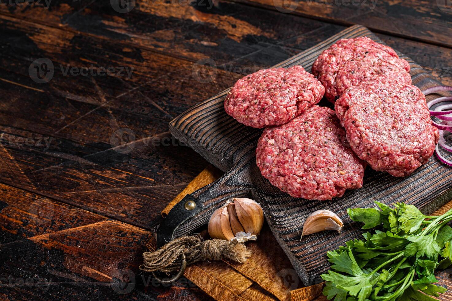 Fresh Raw burger patty, mince beef Meat, uncooked meat cutlets. Wooden background. Top view. Space for text photo