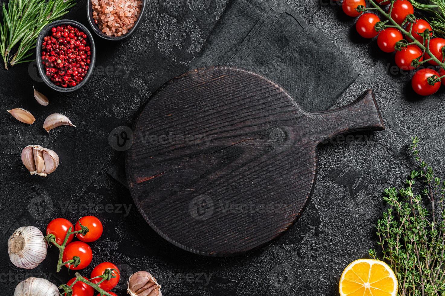 Ingredients for cooking and empty cutting board on old wooden table, Food cooking and healthy eating background. Black background. Top view. Copy space photo