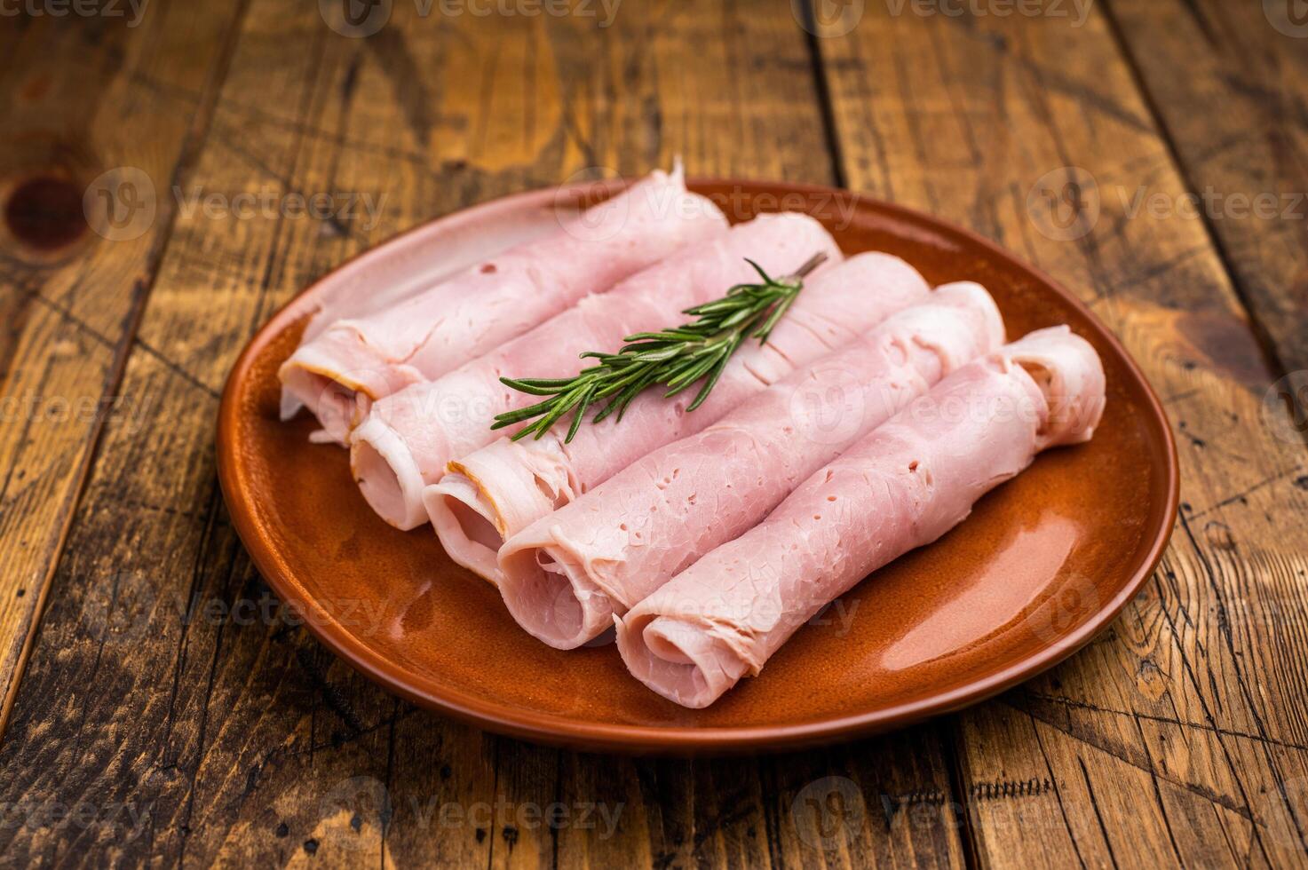 Italian Sliced Prosciutto Cotto ham on plate. wooden background. top view photo