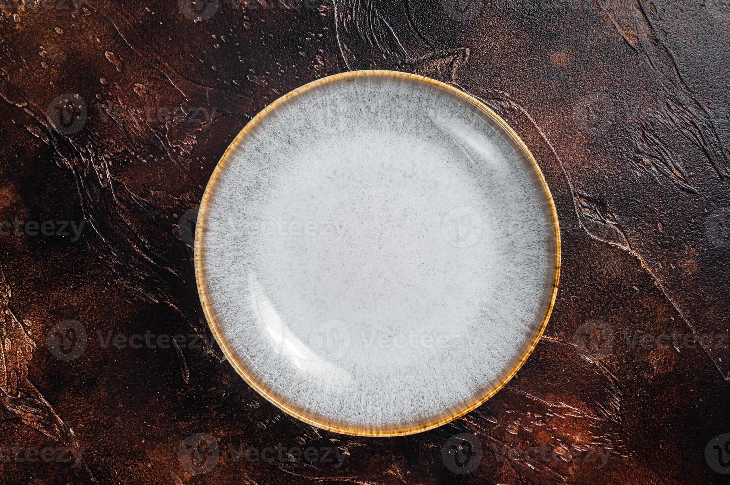 Table setting with vintage empty white plate on rustic wood. Dark background. Top view. Copy space photo