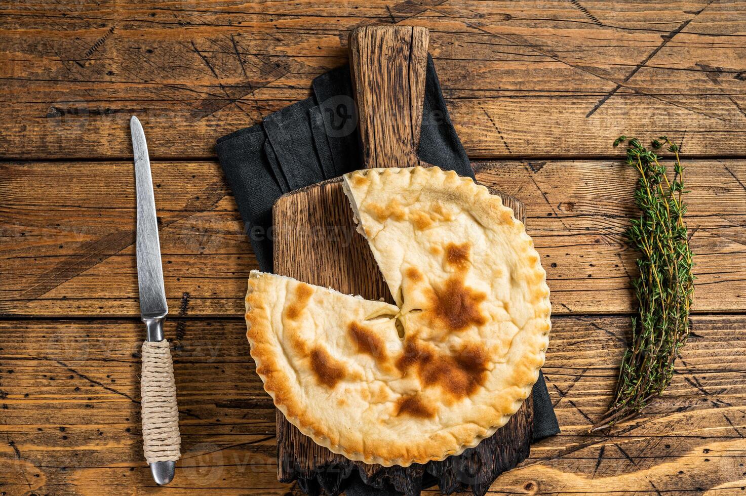 Kubdari Bread, Tasty Flat Bread Stuffed with Spiced meat. Wooden background. Top view photo