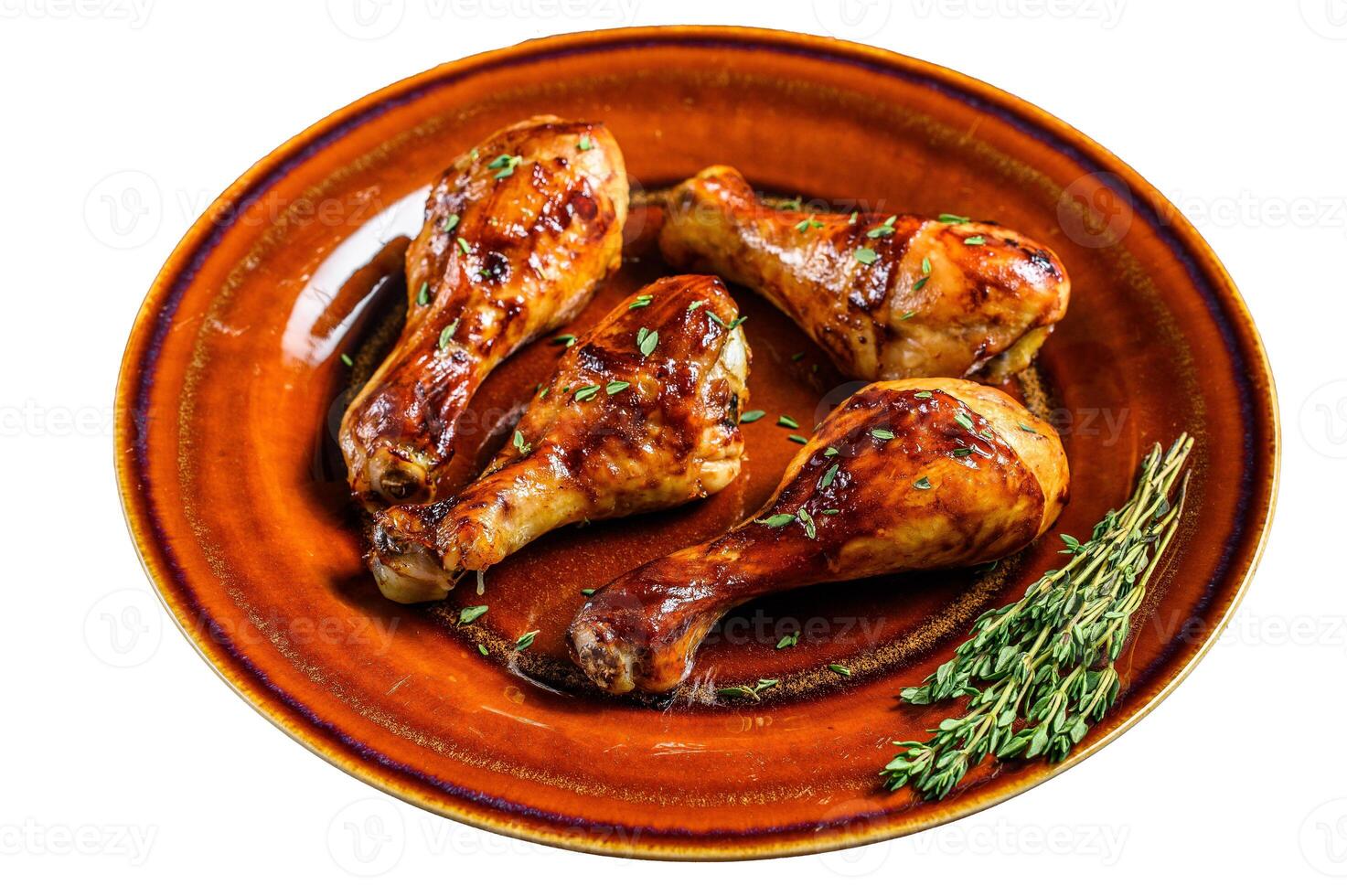 Hot and spicy bbq chicken drumsticks in a plate. Isolated on white background. photo