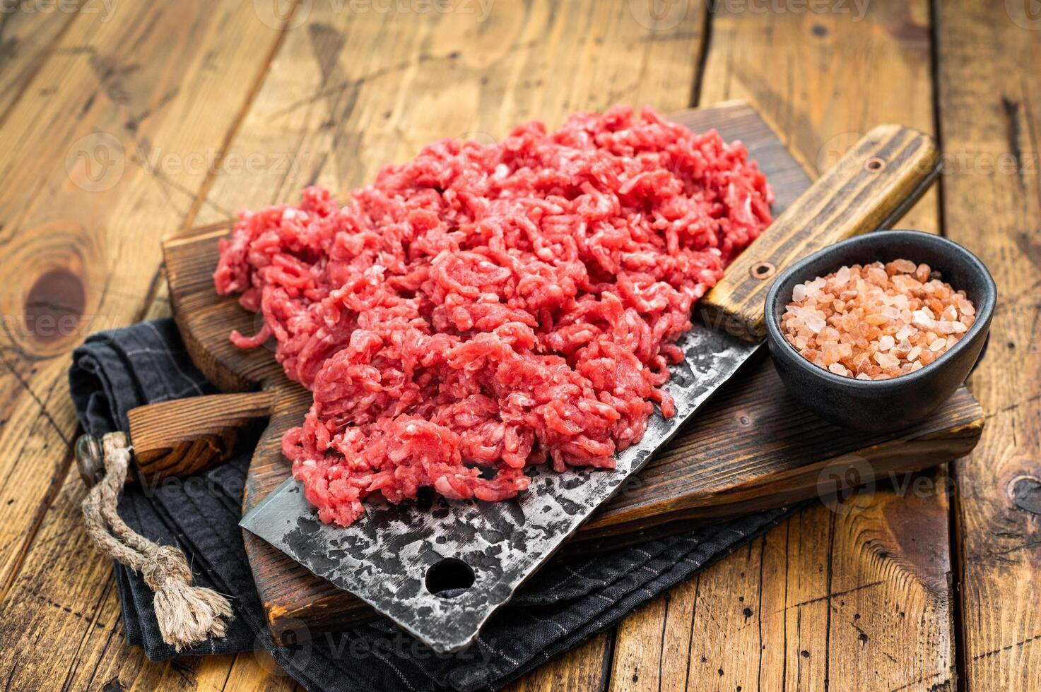 Chopped ground beef and pork raw meat, mince on a cutting board, top view. photo