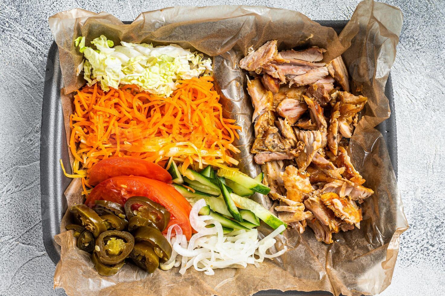Doner kebab Shawarma on a plate with french fries and salad in box to go, take away. White background. Top view photo