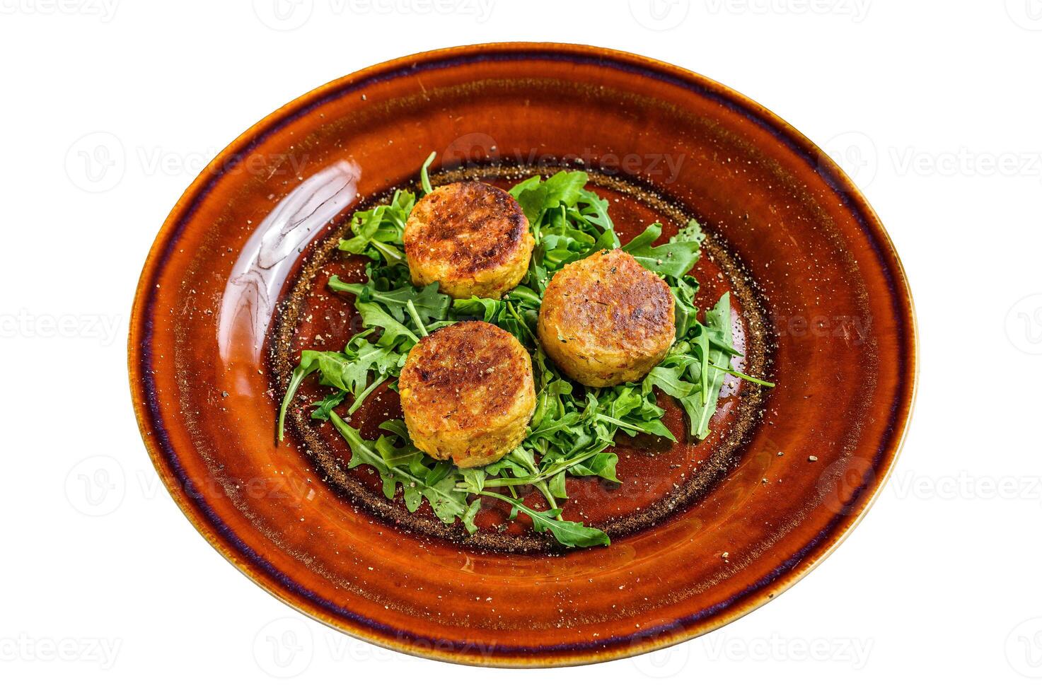 Roasted chickpeas falafel patties with arugula on a plate. Isolated on white background. photo