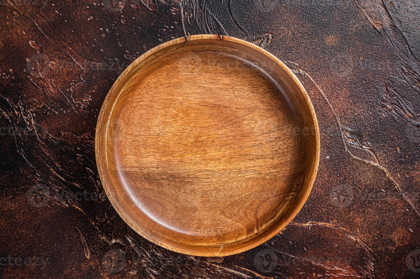 Table setting with vintage empty wooden plate on rustic wood. Dark background. Top view. Copy space photo