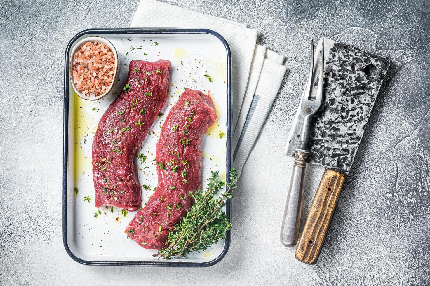 Fresh lamb sirloin meat, Mutton tenderloin fillet with herbs and spices ready for cooking. White background. Top view photo