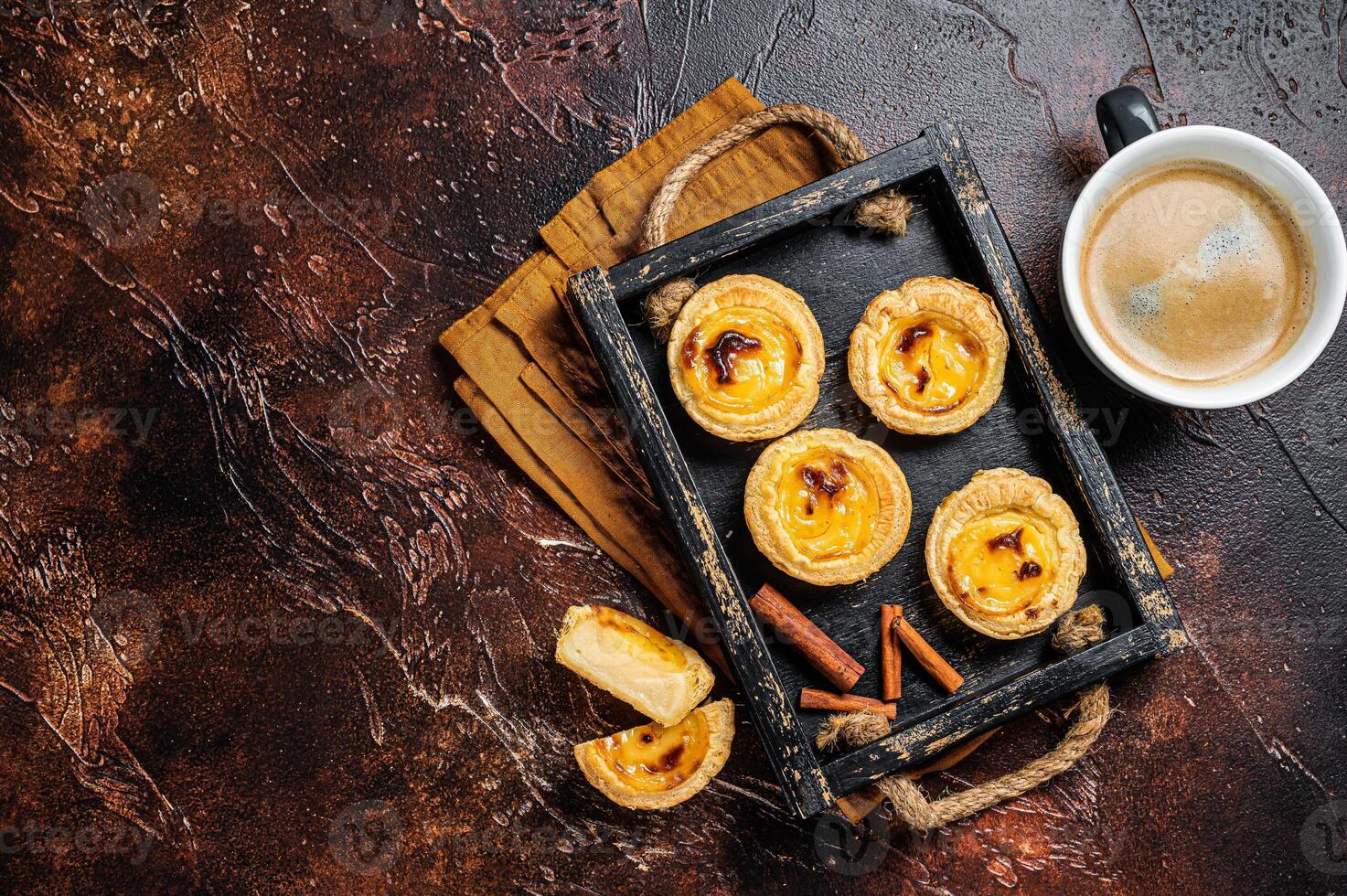 Belem cakes or Pasteis de Belem, Portuguese pastel de Nata Custard Tarts. Dark background. Top view. Copy space photo