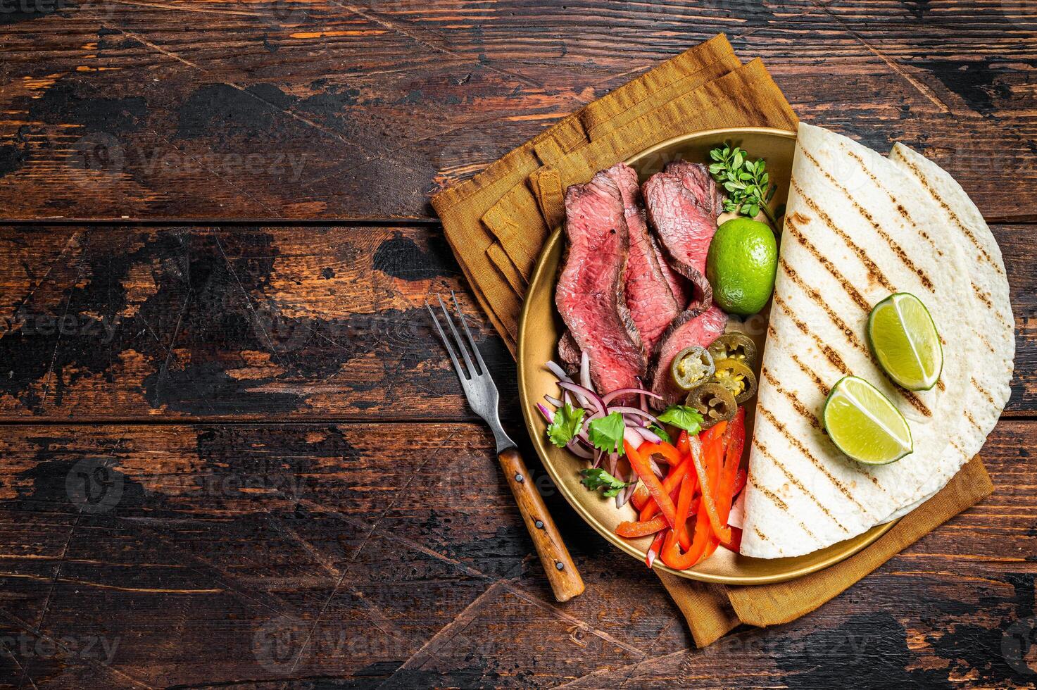 Mexican fajitas for grilled beef steak and vegetables. Wooden background. top view. copy space photo