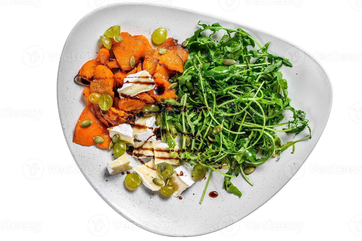 Grilled pumpking warm salad with arugula, walnuts and brie cheese. Isolated on white background. photo