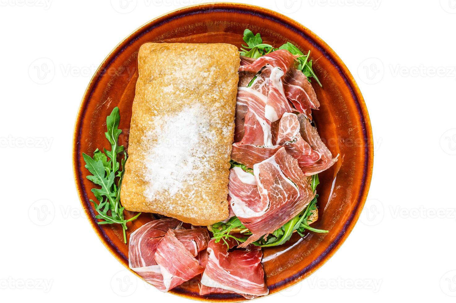 Spanish bocadillo de jamon, serrano ham sandwich on ciabatta bread with arugula. Isolated on white background. photo
